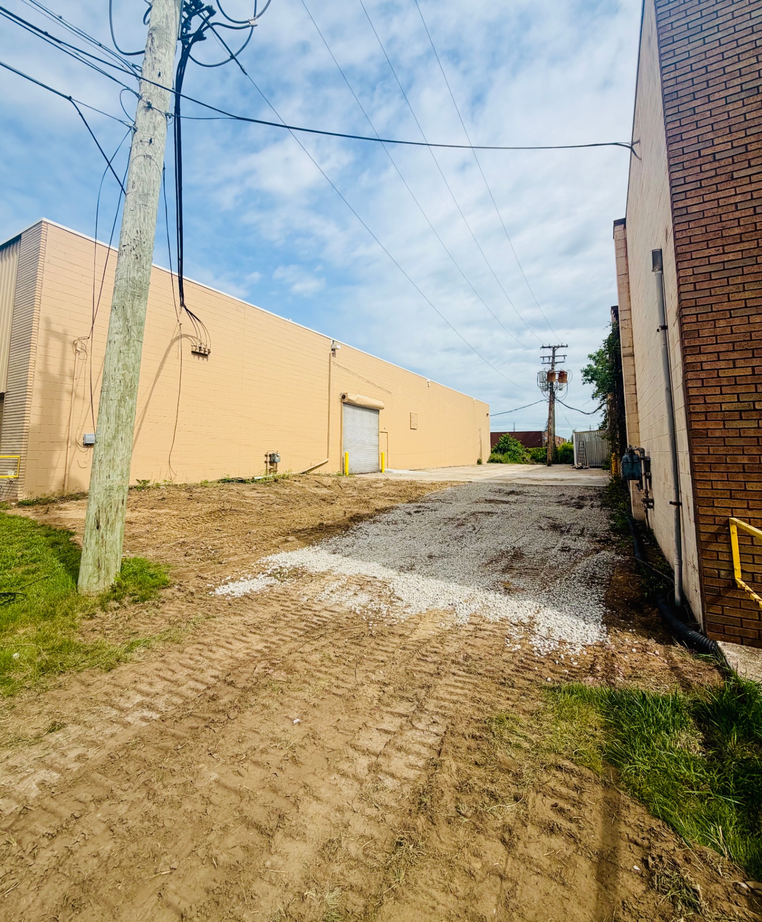 After dumpster rental cleanup in Livonia Michigan — commercial lot fully cleared, graded, and topped with fresh gravel